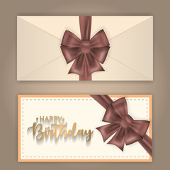 Birthday greeting envelope decorated with bow and ribbon.