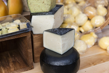 Heads of natural organic homemade cheese on the market.