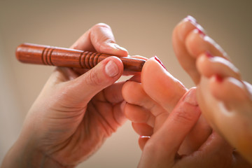 Massage therapist massaging legs of pregnant woman