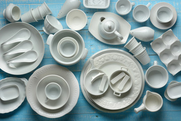 white porcelain kitchenware on light blue wooden table