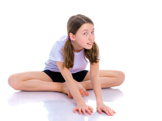 The gymnast perform an acrobatic element on the floor.