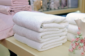 Obraz na płótnie Canvas White terry towels are folded by a pile