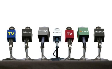 Press interview microphones on a table over white