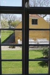 Fototapeta premium View through window at nice old house.