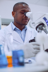 How interesting. Clever professional biologist working with his microscope and wearing a uniform