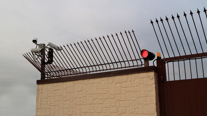 Security surveillance camera on the fence.