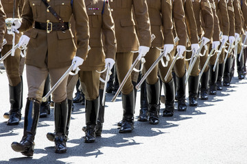 British military servicemen parade in uniform