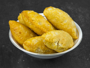 Gujiya or Gujia is a indian sweet dumpling made with suji, Maida or wheat flour and stuffed with khoya. It is common in North India, particularly in Bihar, Uttar Pradesh, Madhya Pradesh or Rajasthan
