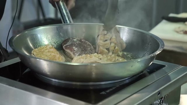 Cooking onions in a frying pan. Clip. Frying onions in a cast iron pan