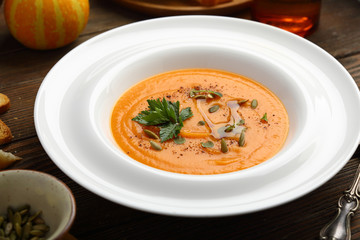 Pumpkin soup in white plate