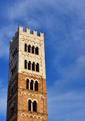 Fototapeta na wymiar Lucca Cathedral medieval bell tower, erected in the 13th century (with clouds and copy space)