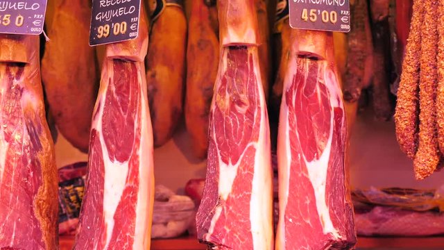 Dry-Cured Ham (Jamon) cuts in La Boqueria market, Barcelona - Dolly shot