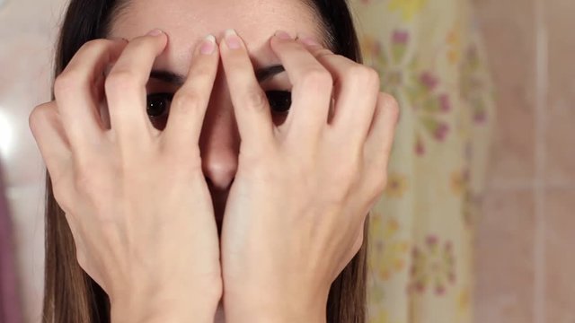 Gymnastics for a face, woman doing anti-aging exercises. Facebuilding facial exercises. Face yoga. Close-up