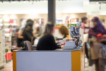 Istanbul, 01 may 2018: Cash desks with cashier serves customers on blurry background, Turkey