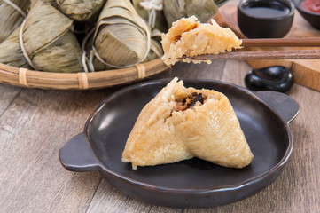 A man is going to eat zongzi or rice dumpling on Dragon Boat Festival, Asian traditional food