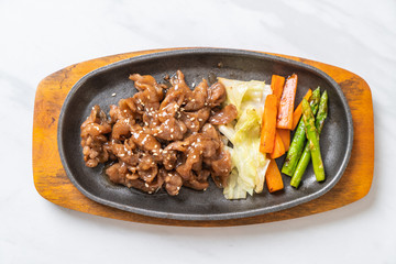 sliced pork steak on hot plate