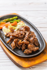 sliced pork steak on hot plate