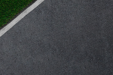 Fototapeta premium the asphalt which is smoothly passing to a white border and a green grass