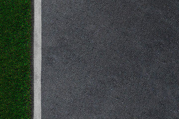 Fototapeta premium Asphalt road with white lines and green grass background