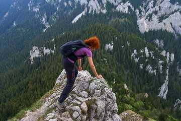 Woman climbing into the mountains