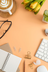 Flat lay, top view office table desk. Workspace with blank note book, keyboard, office supplies  and coffee cup on color background.
