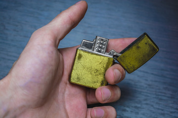 Fototapeta premium hand-held golden folding lighter