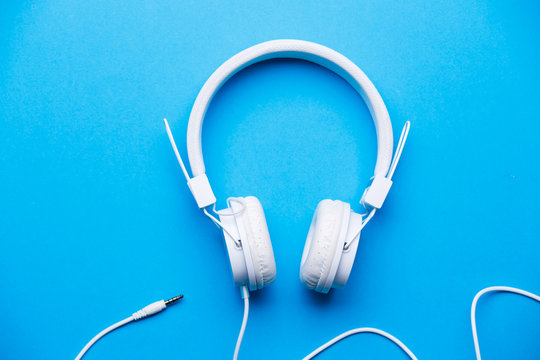 Image of white headphones on blue background