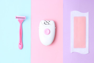 a set of means of hair removal. Wax strips, modern epilator and razor on a colored background. Minimalism, choice. top view, flatlay 