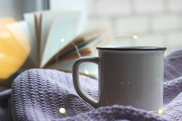 a garland, a cup, a plaid and a book on the windowsill. minimalism, top, insta