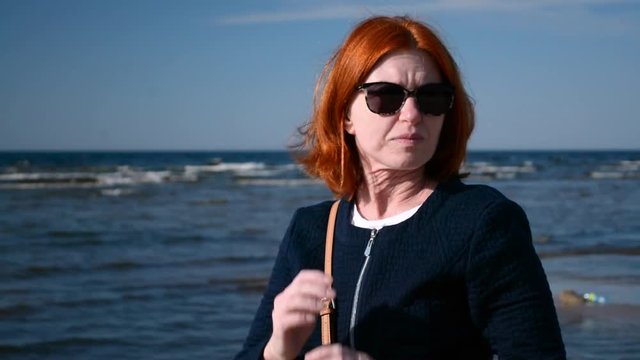 Portrait of busines woman in sunglasses enjoying the sn and the sea