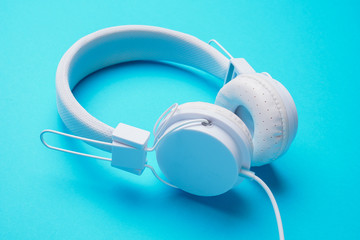 Picture of white headphones on blue background