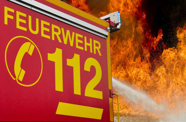 112- Feuerwehreinsatzfahrzeug vor Flammenhintergrund 