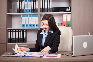 Female businesswoman in formal suit in her office