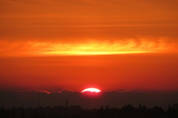 Beautiful sunset view over the city, the sun sets over the horizon 