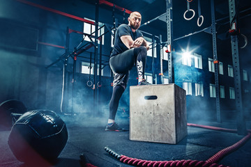 Man standing during exercises in the fitness gym. CrossFit.