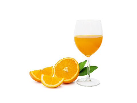 a glass of fresh orange juice and group of fresh orange fruits with green leaves, isolated on white background, clipping path include. fruit product display or montage, studio shot