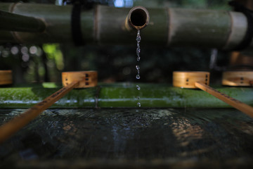 Water from bamboo and Water bamboo bowl for cleaning hand and mouth before worship in temple and shrine in Japan.