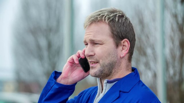 A man answers his cell phone and then he talks to someone on the phone.