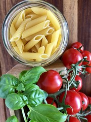 pasta with tomatoes on wooden background, flatlay
