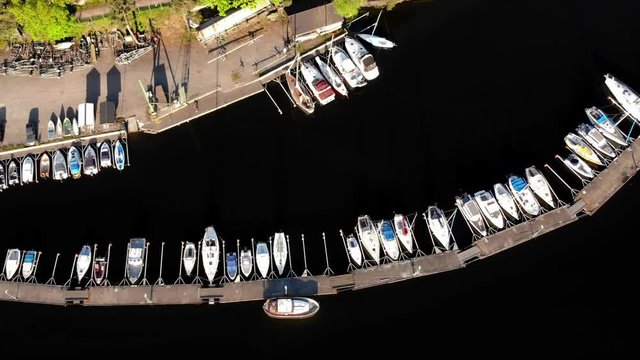 Aerial footage of the Stockholm island Stora Essingen and one of its lake marinas.
