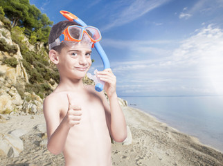 Happy little boy with snorkeling mask enjoying his summer vacations
