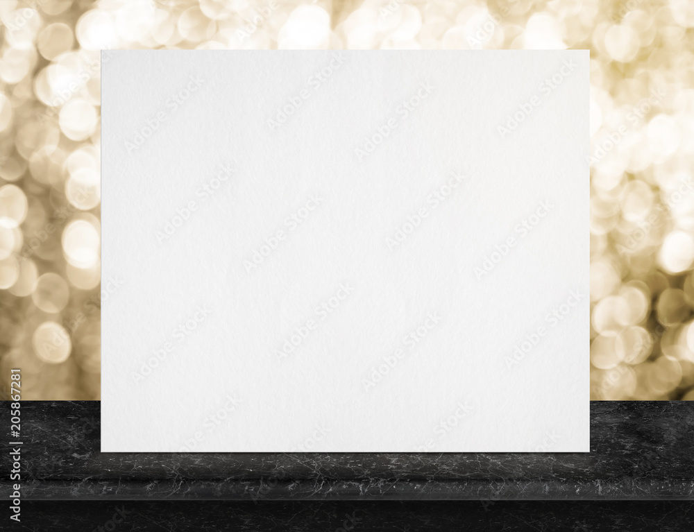 Poster blank white paper poster on black marble table top and sparkling gold bokeh light,mock up to display
