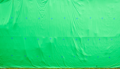 Giant green screen chroma key background on commercial set.