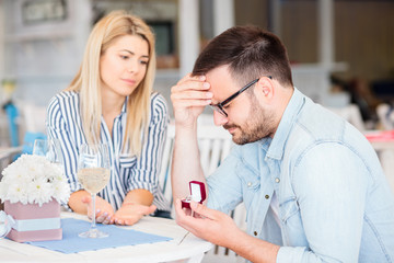 Fototapeta premium Disappointed young man is sad after his girlfriend rejected his marriage proposal.