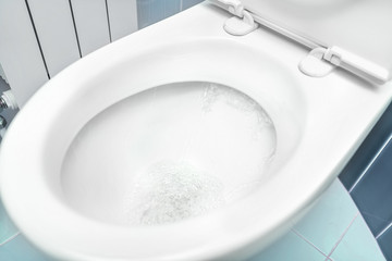 Water flushes the toilet.