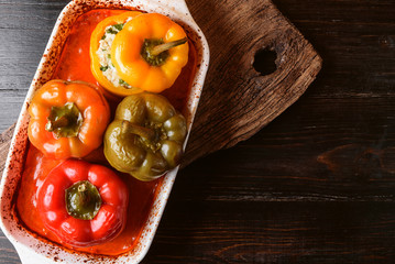 homemade, stuffed peppers. with a filling of basil, spinach, cheese and spices. with gravy from fresh home-made tomatoes. made in a rustic style.