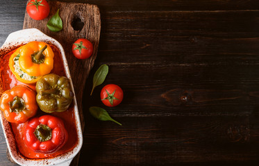 homemade, stuffed peppers. with a filling of basil, spinach, cheese and spices. with gravy from fresh home-made tomatoes. made in a rustic style.