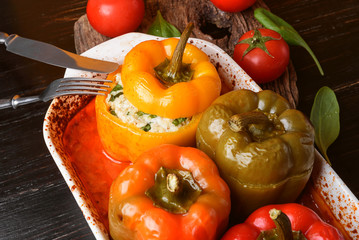 homemade, stuffed peppers. with a filling of basil, spinach, cheese and spices. with gravy from fresh home-made tomatoes. made in a rustic style.