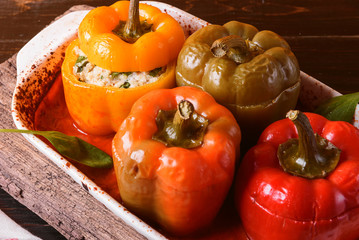 homemade, stuffed peppers. with a filling of basil, spinach, cheese and spices. with gravy from fresh home-made tomatoes. made in a rustic style.