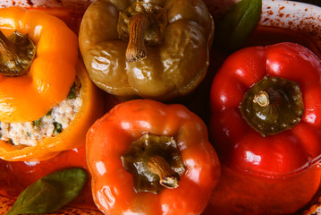 homemade, stuffed peppers. with a filling of basil, spinach, cheese and spices. with gravy from fresh home-made tomatoes. made in a rustic style.